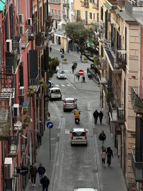 Free An atmospheric street scene in Pozzuoli, Campania, capturing local life and architecture. Stock Photo