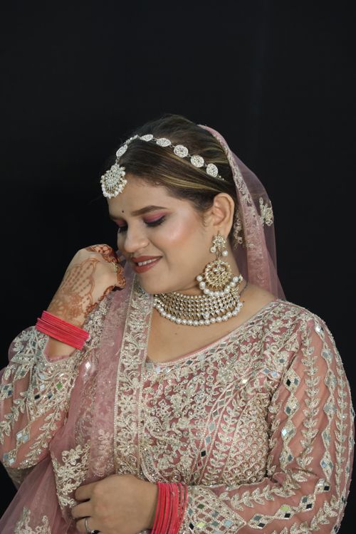 Free Portrait of a smiling woman in exquisite bridal wear, showcasing traditional jewelry. Stock Photo
