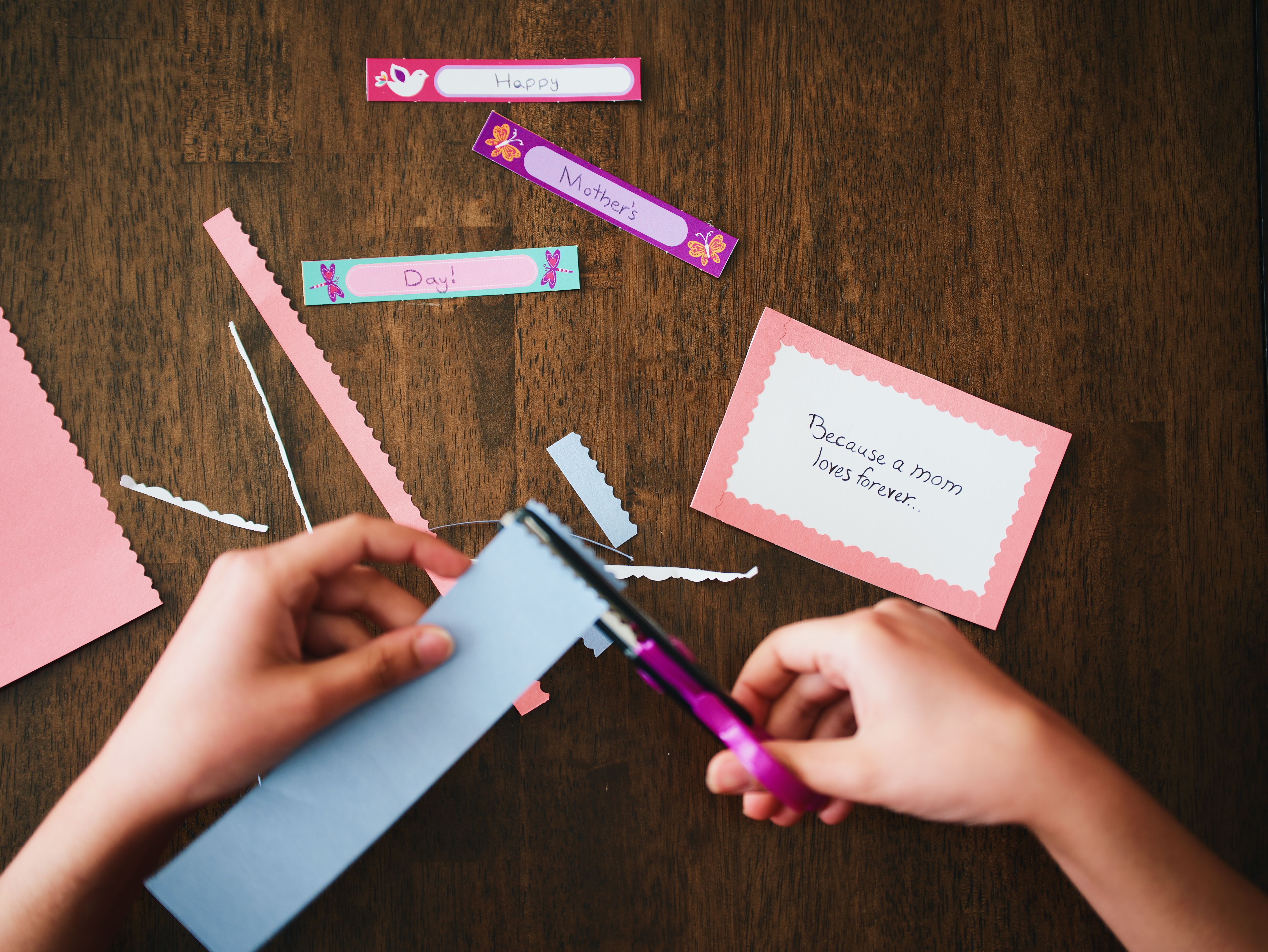 Child making a handprint bouquet card with colorful paper - easy crafts for parent love