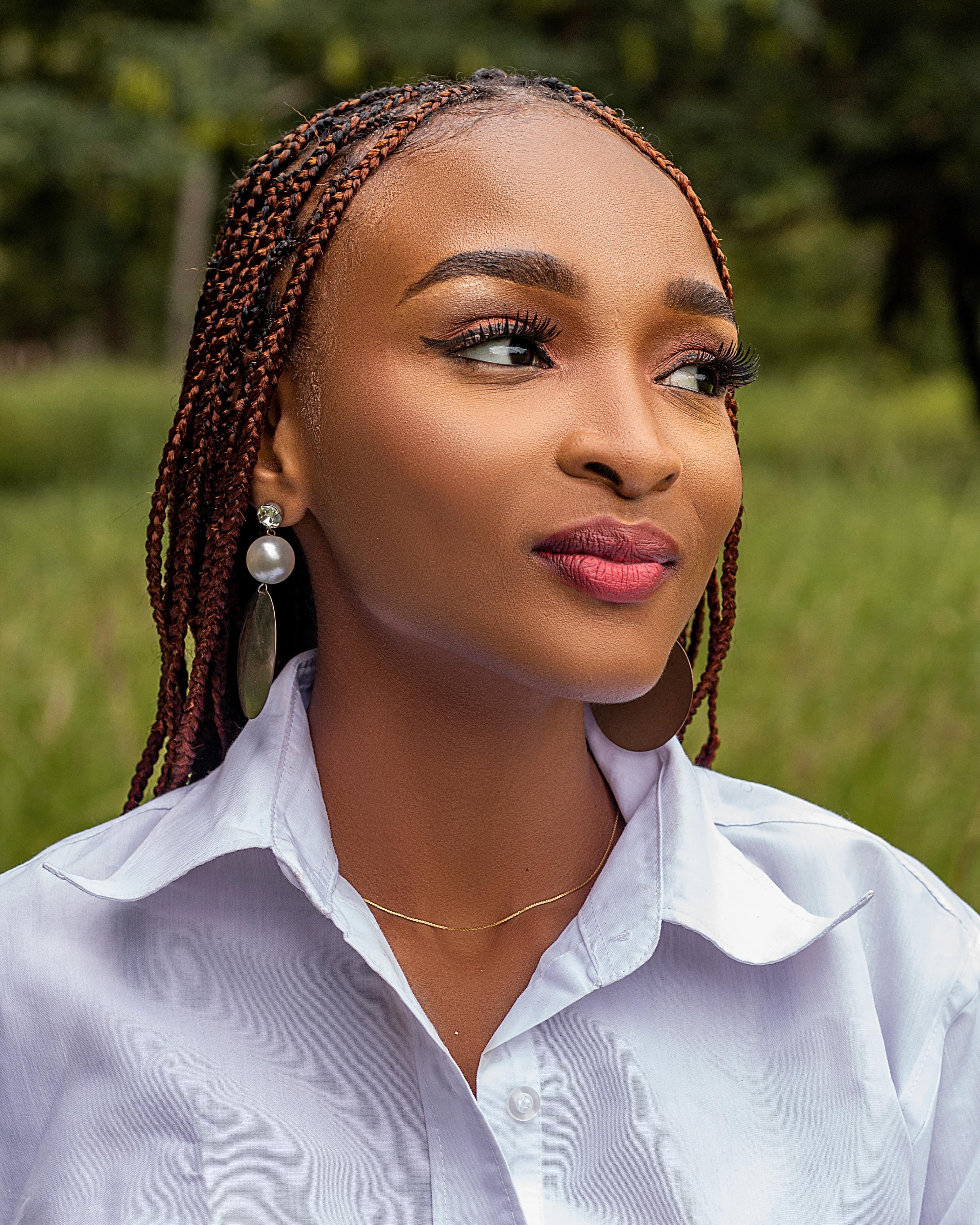 Portrait of Young Woman with Braids Outdoors · Free Stock Photo