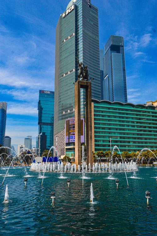 Free Famous Welcome Monument at Bundaran HI with skyscrapers in Jakarta, Indonesia. Stock Photo
