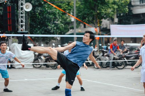 Free Players engage in a lively outdoor sepak takraw game, showcasing agility and teamwork. Stock Photo
