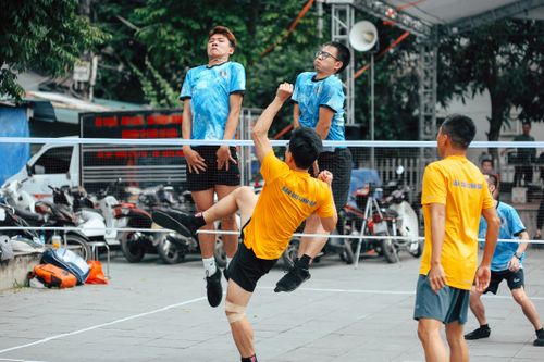 Free Dynamic action shot of players in an intense Sepak Takraw game outdoors. Stock Photo