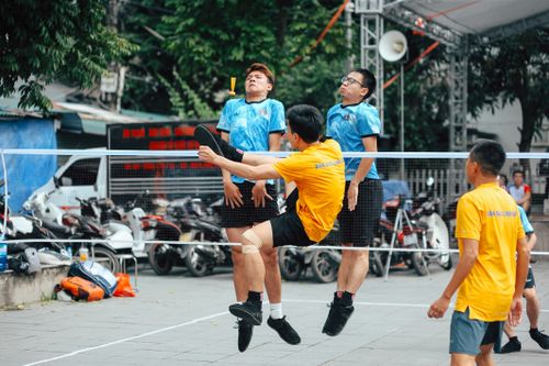Free Exciting sepak takraw match in a lively outdoor city setting, showcasing skill and agility. Stock Photo