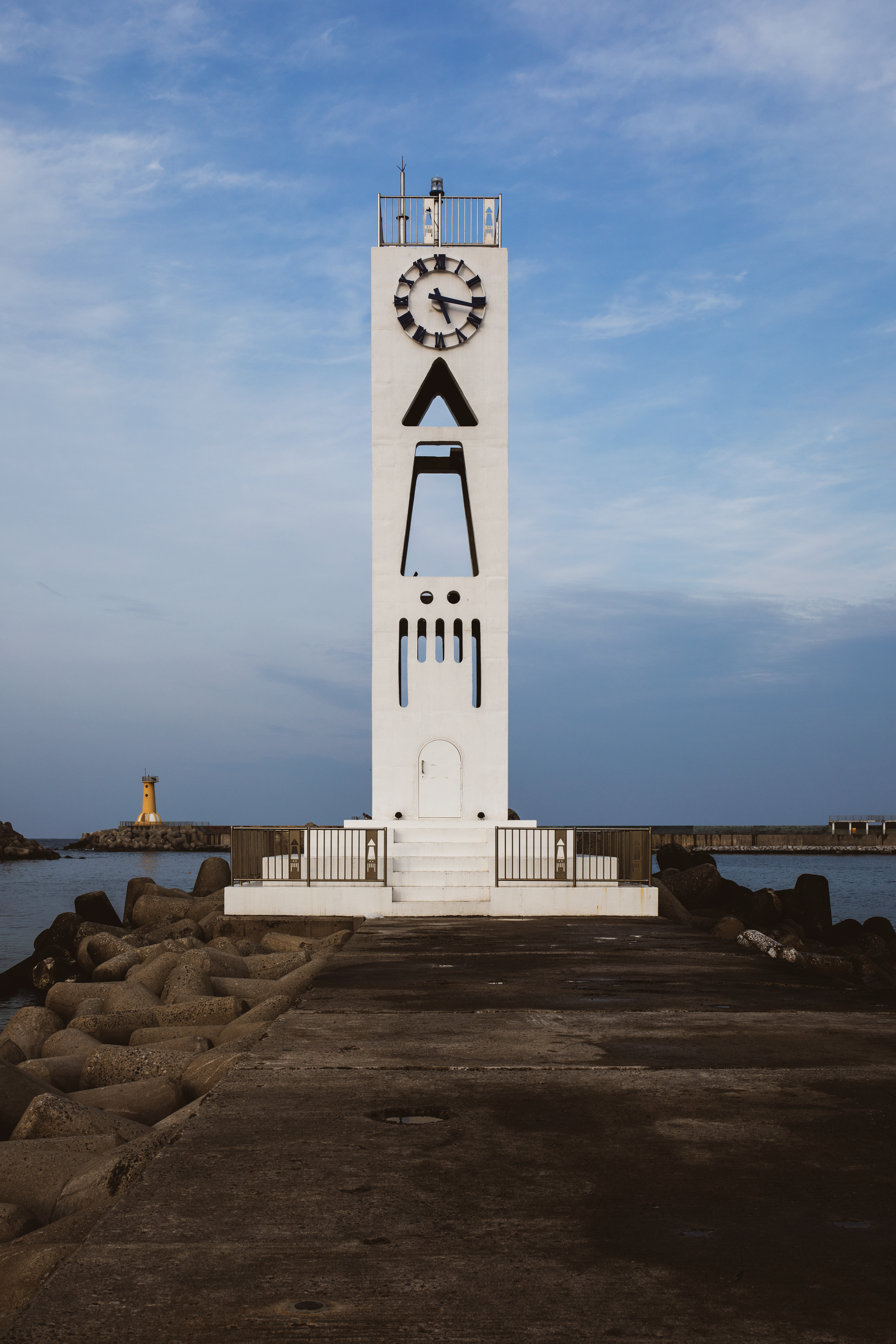 Modern Clock Tower by the Sea with Clear Sky · Free Stock Photo
