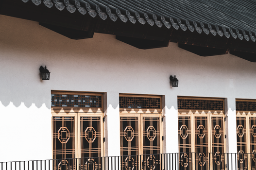 Elegant traditional Asian architecture with wooden lattice doors and shadow play.