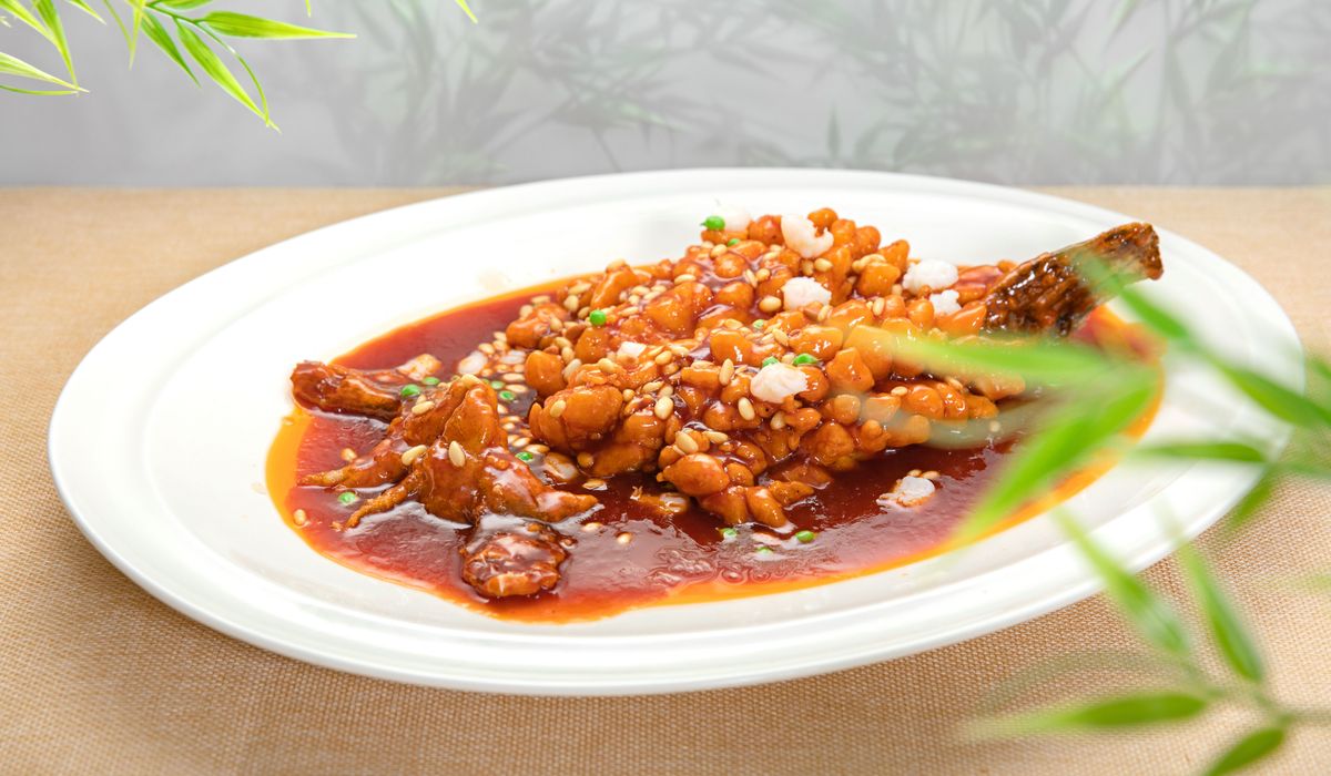 kung pao chicken ingredients — Sichuan peppercorns, dried chilies, peanuts, and soy sauce laid out