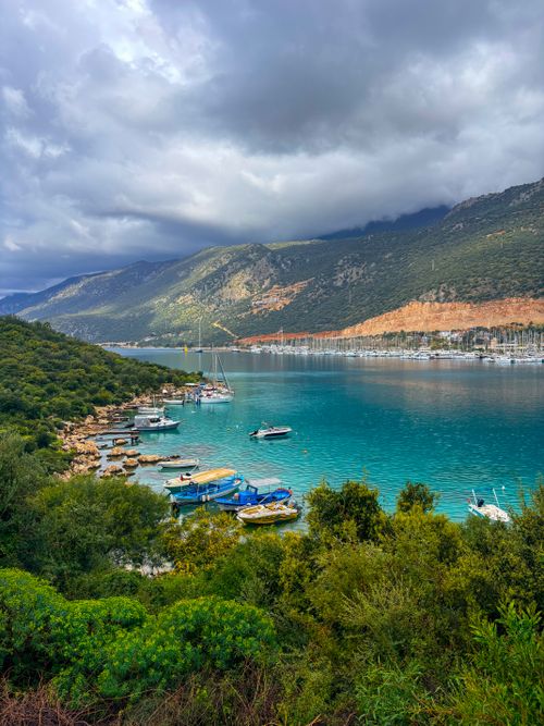 Free Breathtaking view of Kaş harbor with boats, turquoise sea, and lush greenery. Stock Photo