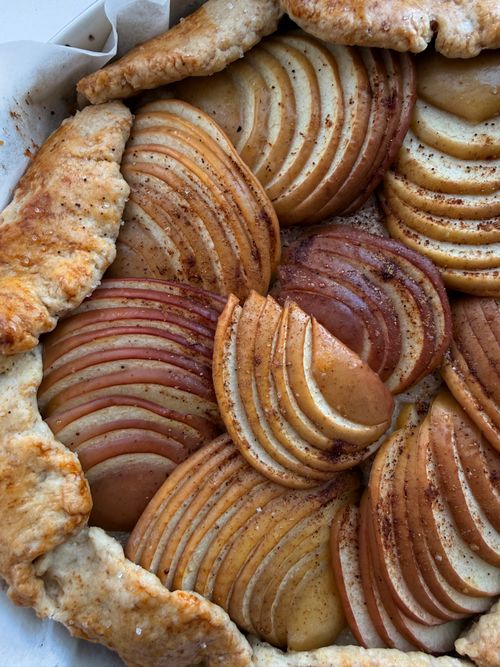 Free Top view of a beautifully arranged homemade rustic apple galette with a golden crust. Stock Photo