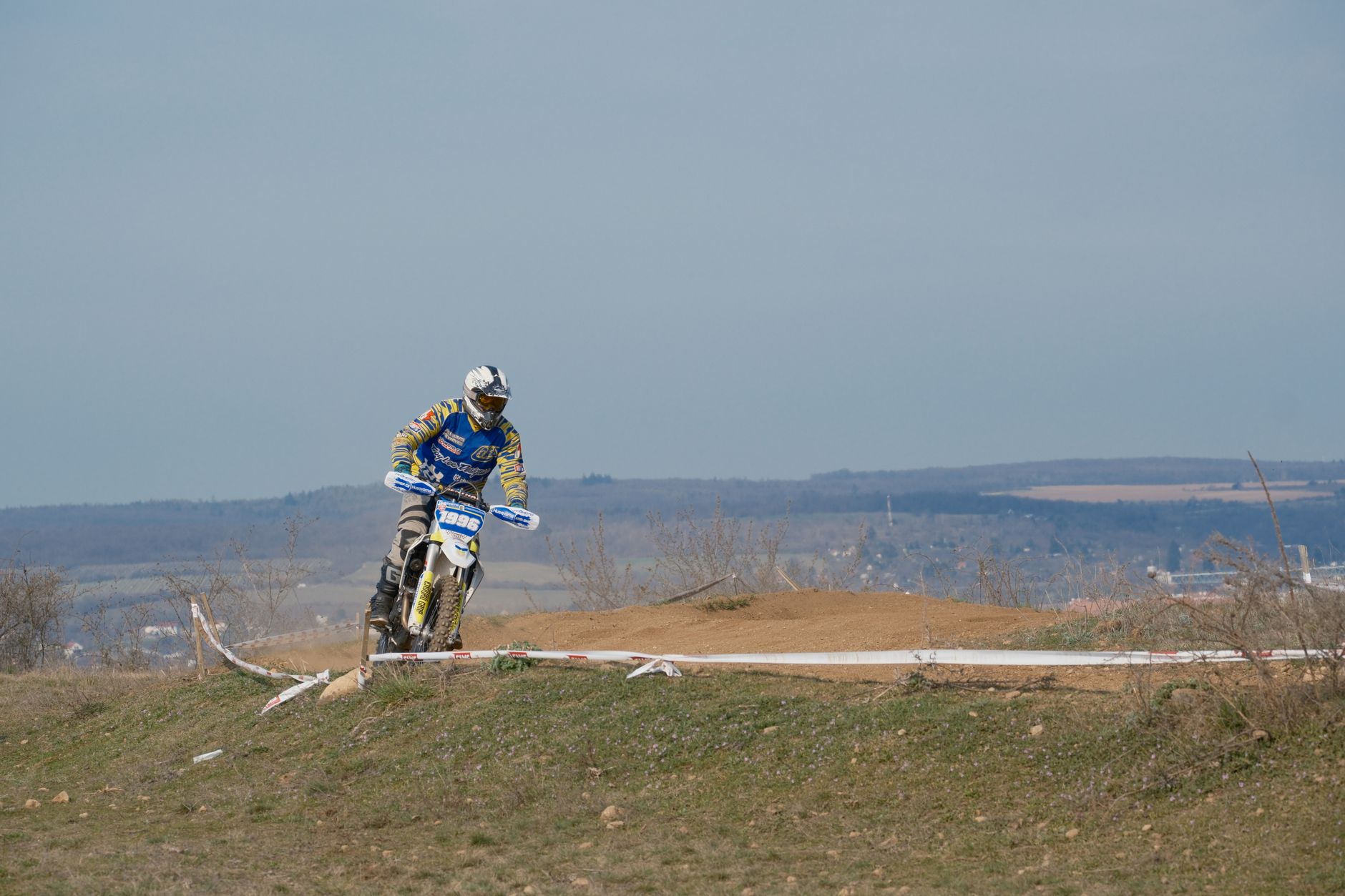 A motorcyclist navigates a dirt track during an outdoor race in Jihomoravský kraj, Czechia.