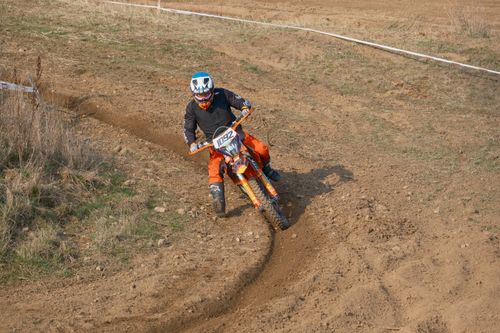Free Motocross rider navigating a dirt track turn in Jihomoravský kraj, Czech Republic. Stock Photo