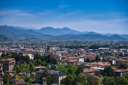 Free A stunning aerial view of Bergamo, Lombardia, Italy, with mountainous background under a clear sky. Stock Photo