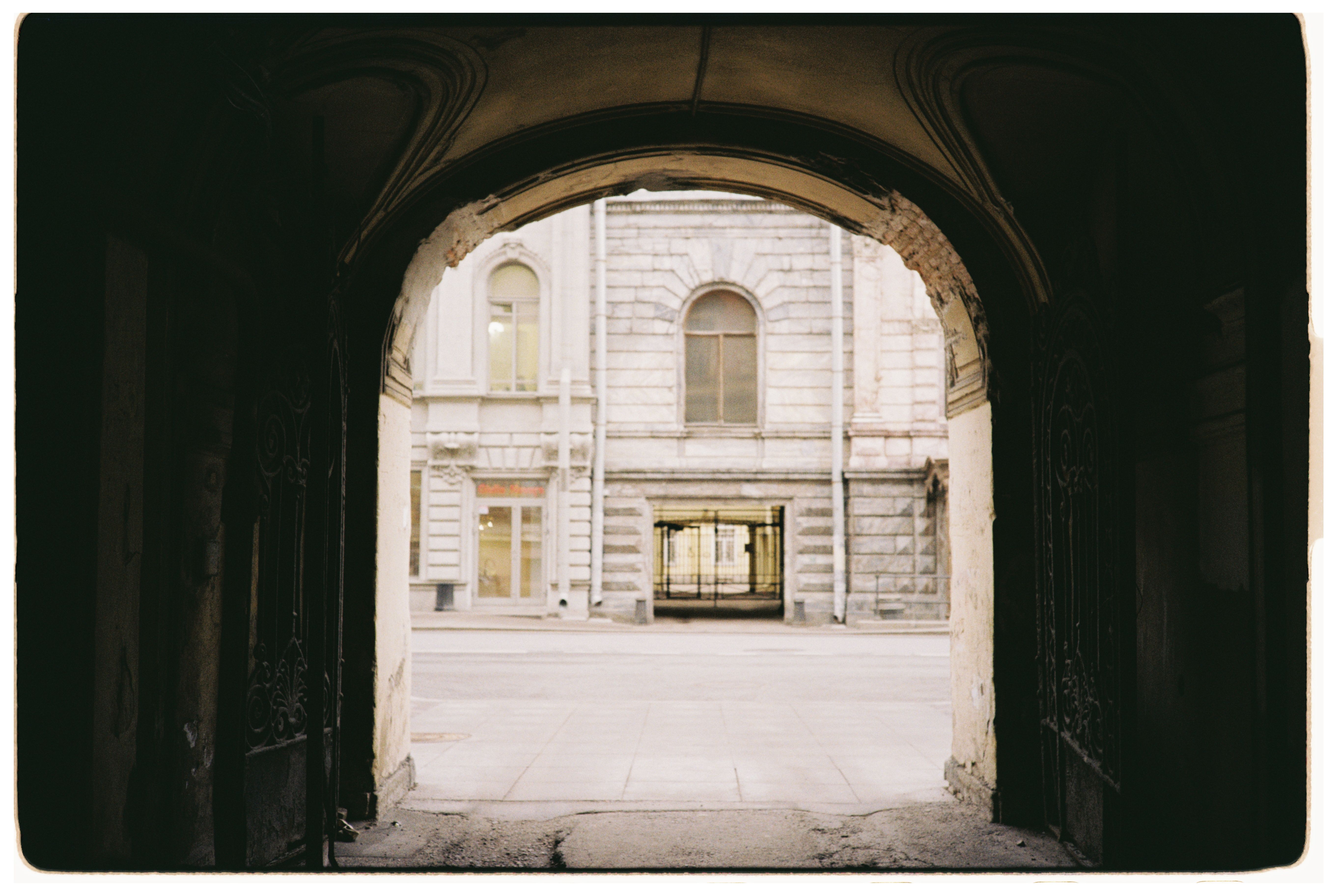Historic Stone Archway View of Urban Street · Free Stock Photo