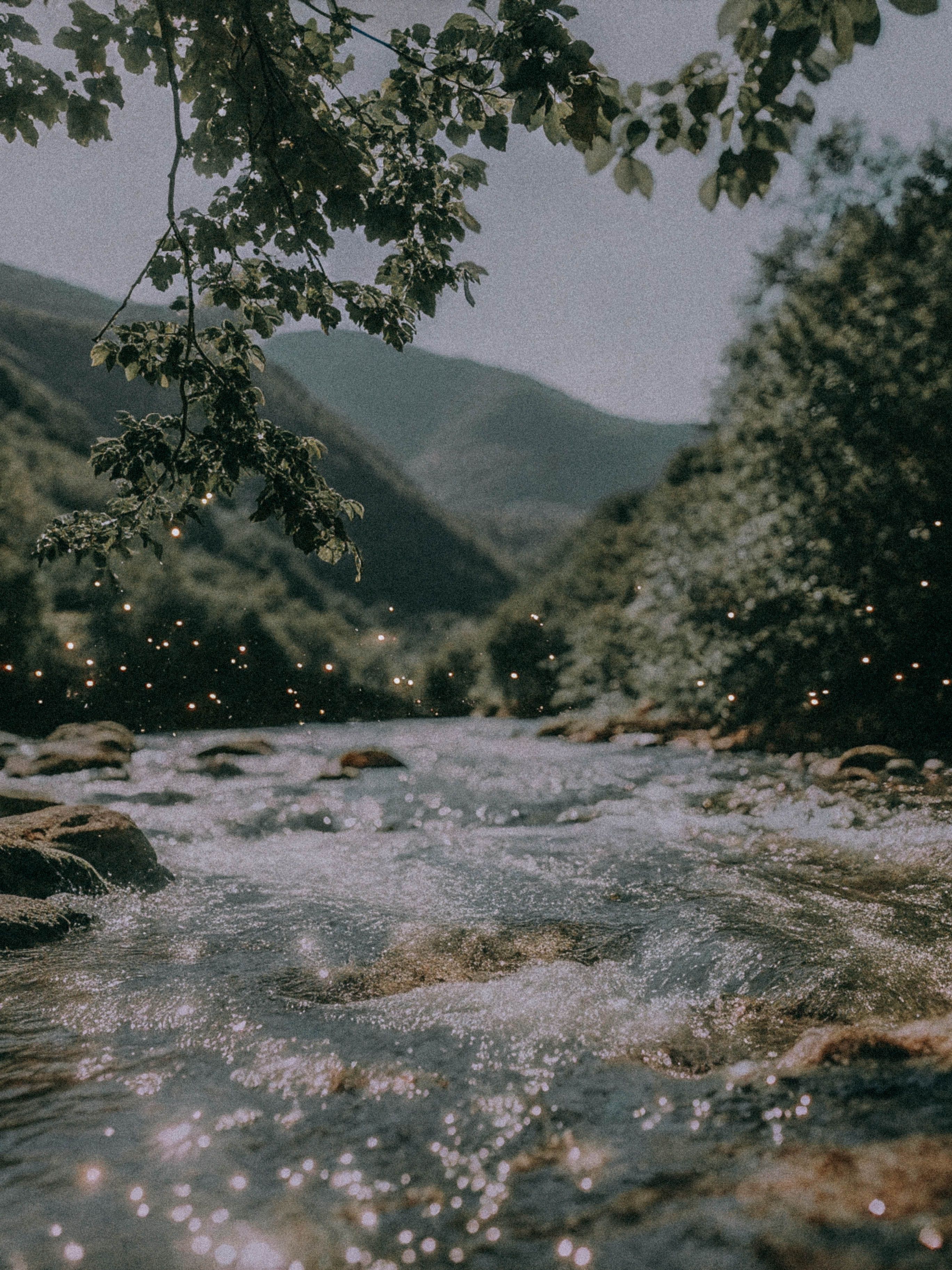 Tranquil River Flowing Through Mountainous Landscape · Free Stock Photo