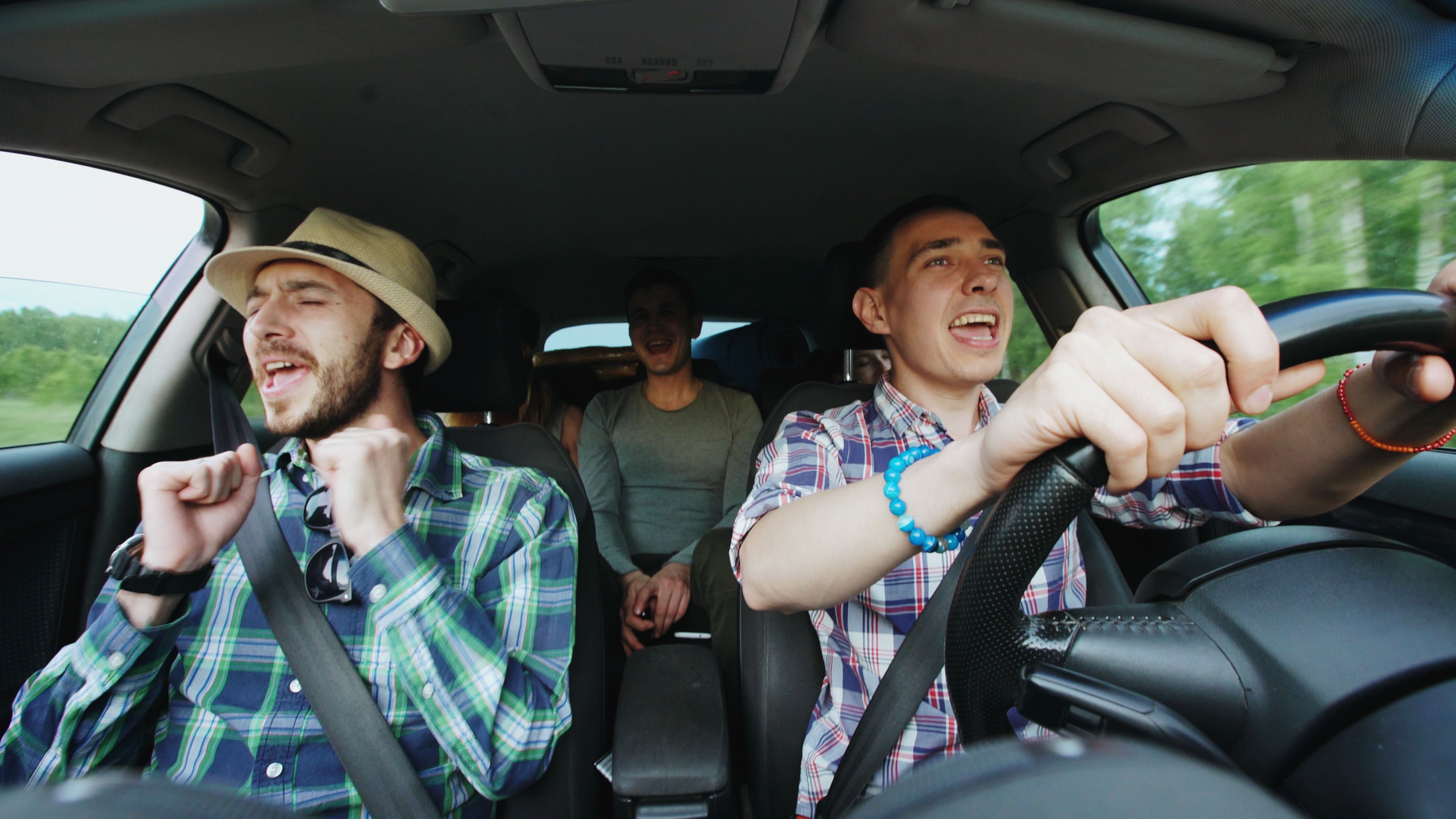 Friends Enjoying Road Trip Singing in Car · Free Stock Photo