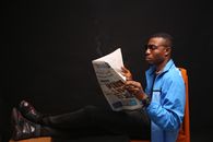 A Man Reading A News Paper