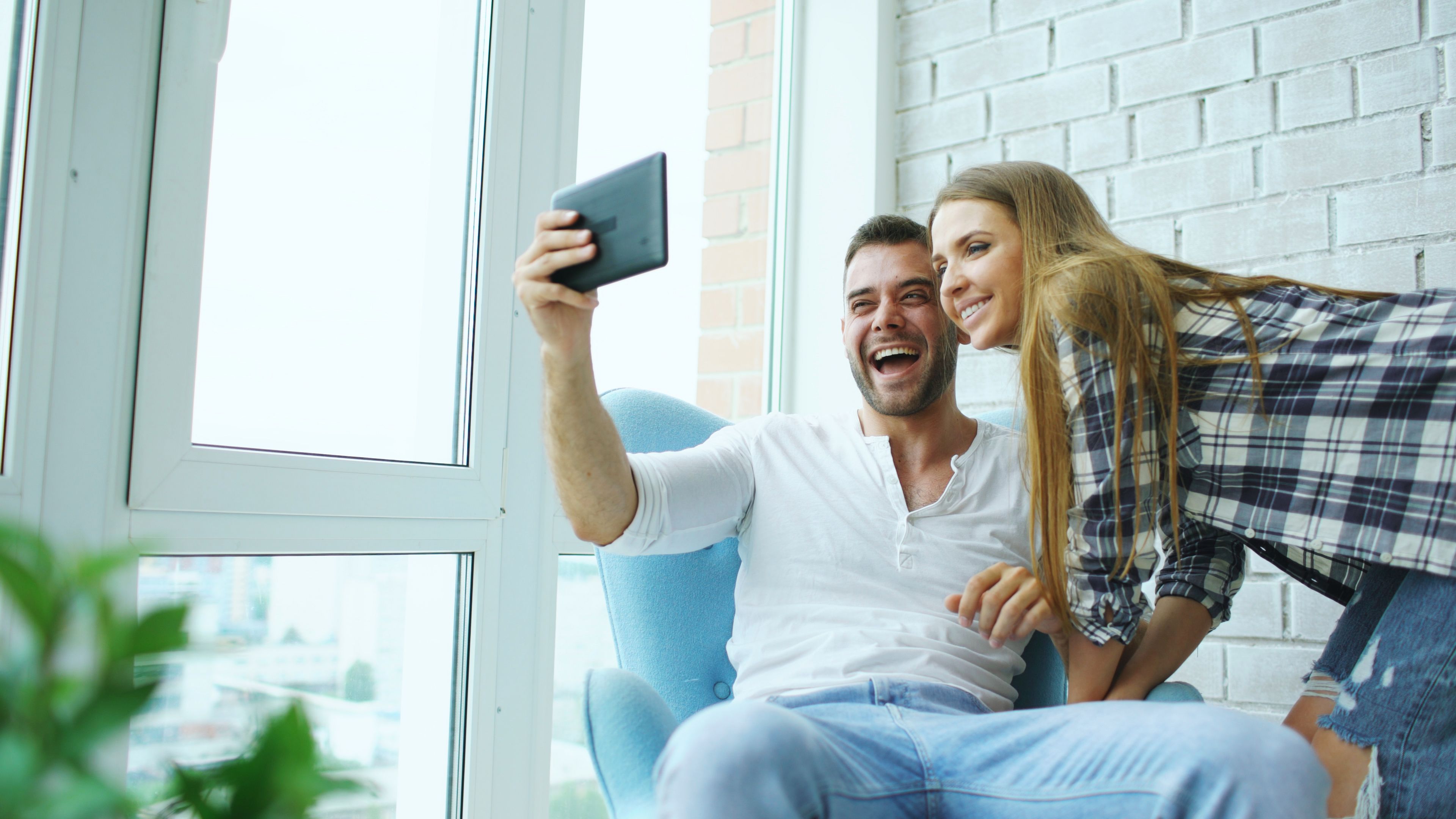 young couple sitting in small modern living room