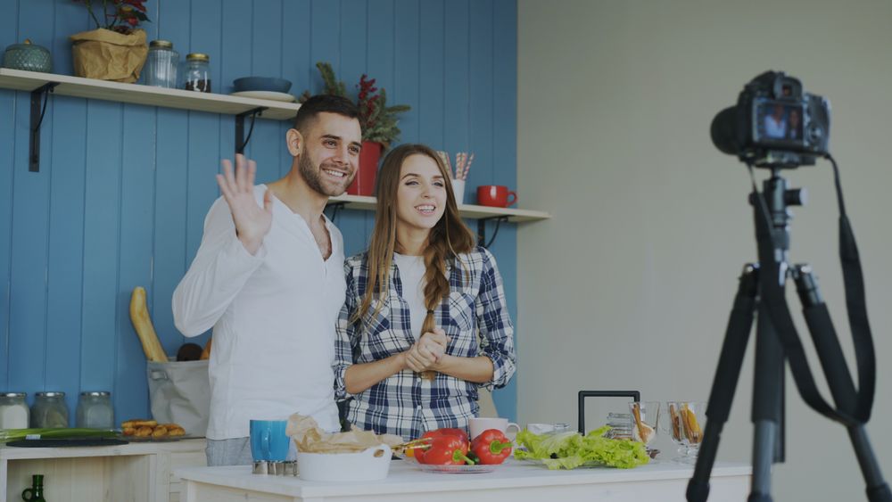 Two creators filming a cooking video together