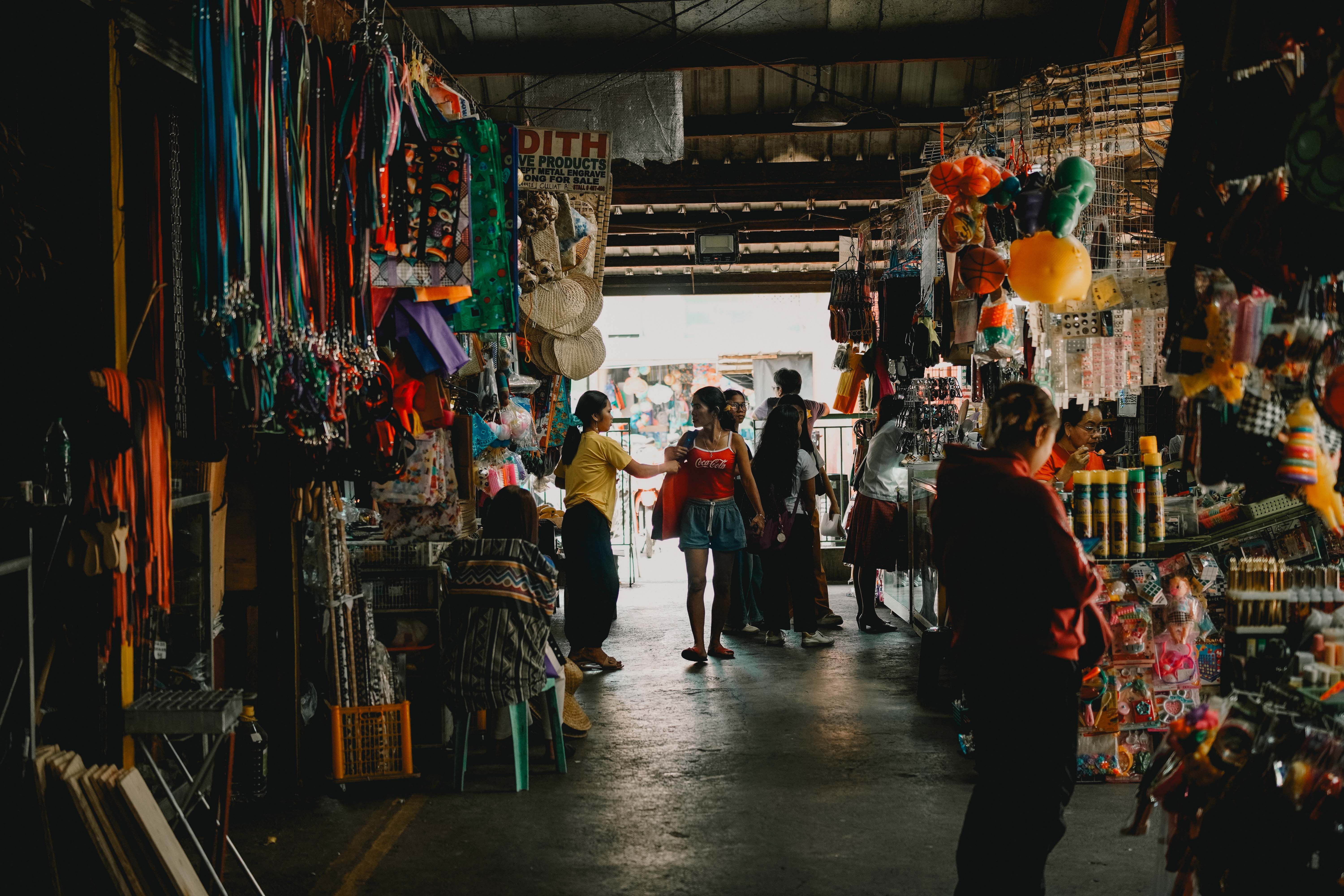 Bustling Indoor Market with Shoppers and Stalls · Free Stock Photo