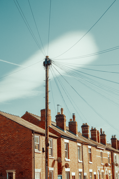Free Charming view of Victorian terraced houses and telegraph pole under a vivid blue sky in Shrewsbury, England. Stock Photo