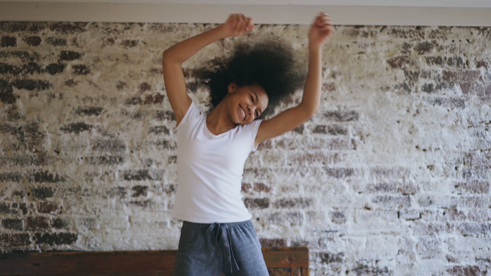 Smiling dancer mid-move, capturing the joyful energy worth turning into a social caption
