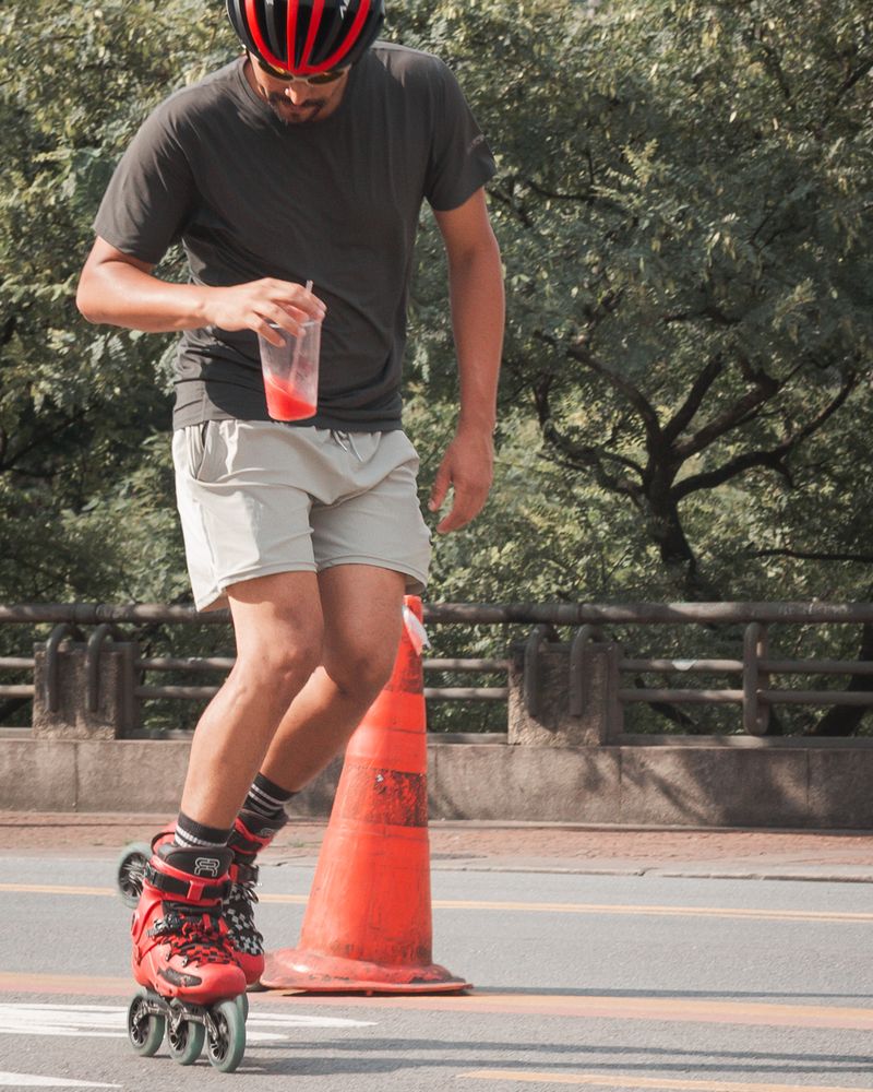 Man rollerblading outdoors in a sunny park