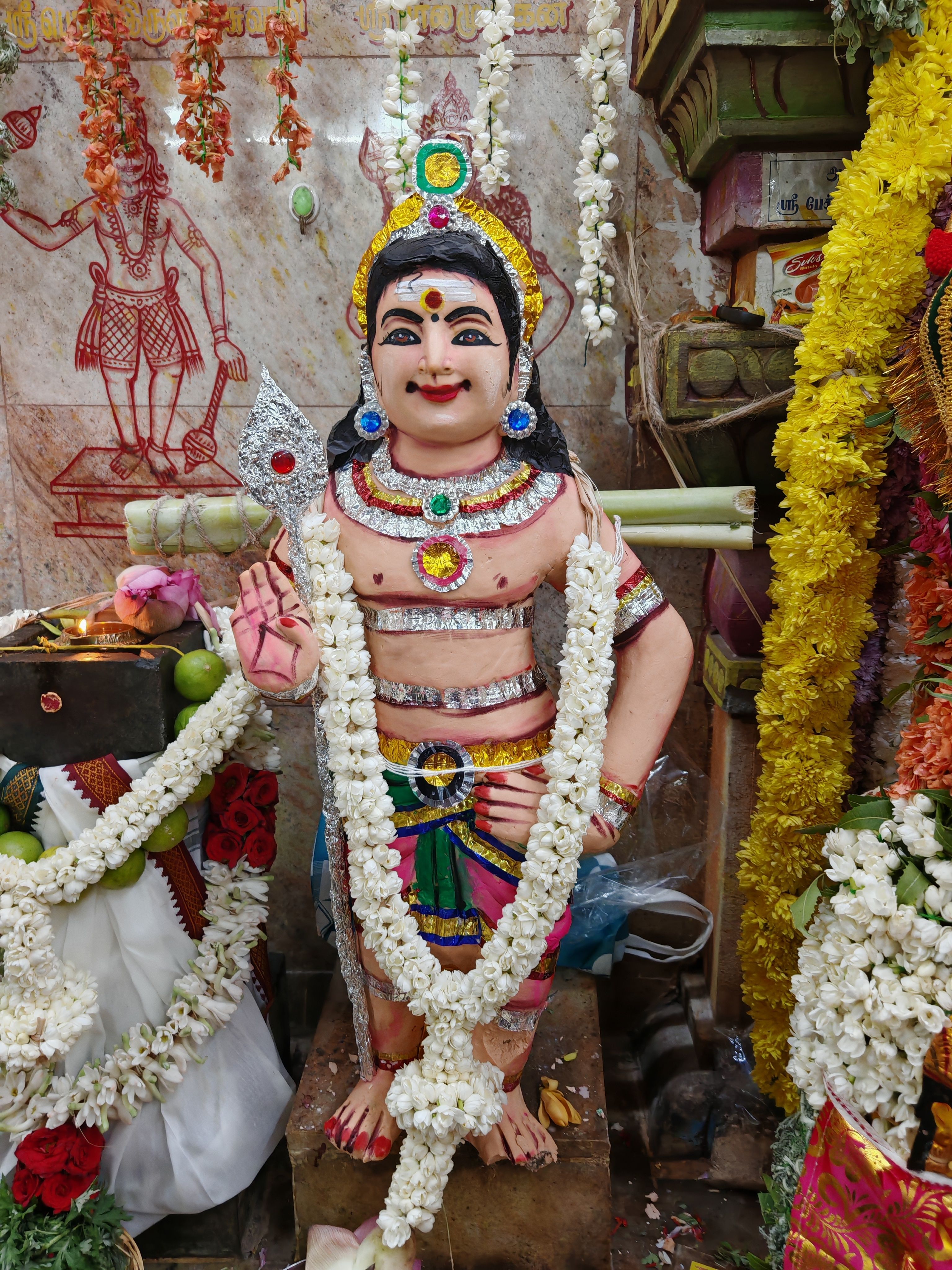 Vibrant Ganesha statue adorned with flowers and ornaments, showcasing Indian culture in Sivakasi, Tamil Nadu.