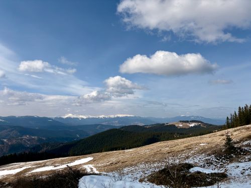 Free A breathtaking view of the Carpathian Mountains in late winter, showcasing snow-dusted peaks and clear blue skies. Stock Photo