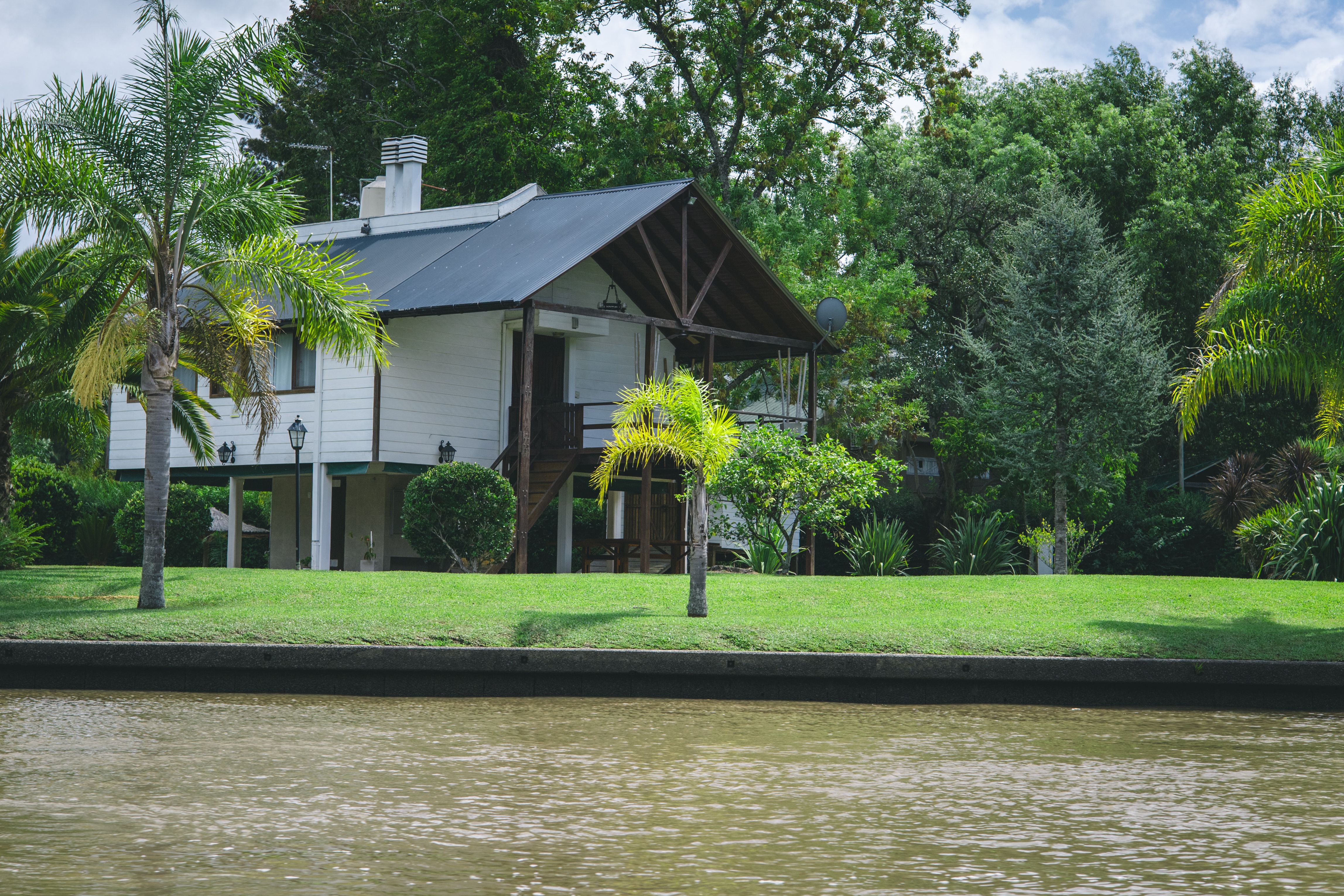 Peaceful river frontage with calm water and native trees at High View Waters resort