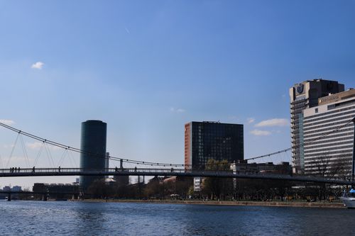 Free Scenic view of Frankfurt skyline featuring a prominent bridge over the Main River under a clear blue sky. Stock Photo