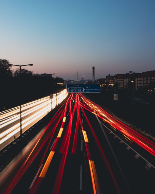Free Capture the dynamic light trails of vehicles on a Berlin highway at dusk with this long exposure photograph. Stock Photo