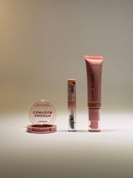 Three makeup products in elegant minimalist display, perfect for beauty brands.