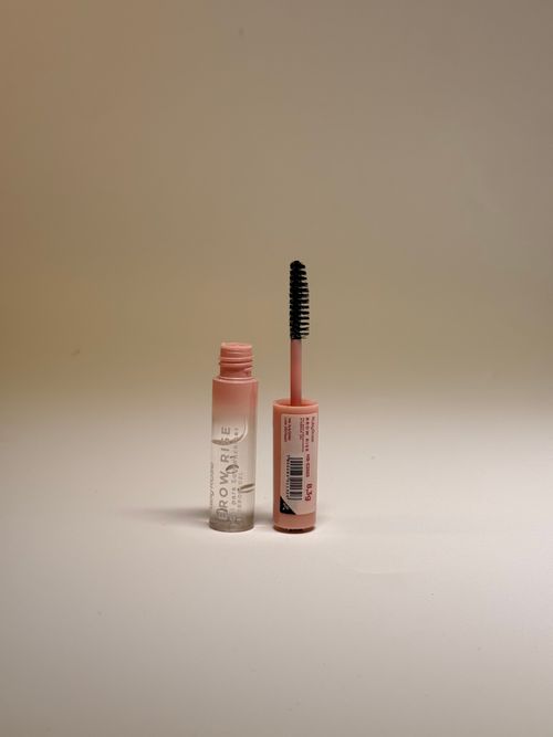 Free Simple cosmetic product shot featuring open mascara tube on neutral background. Stock Photo