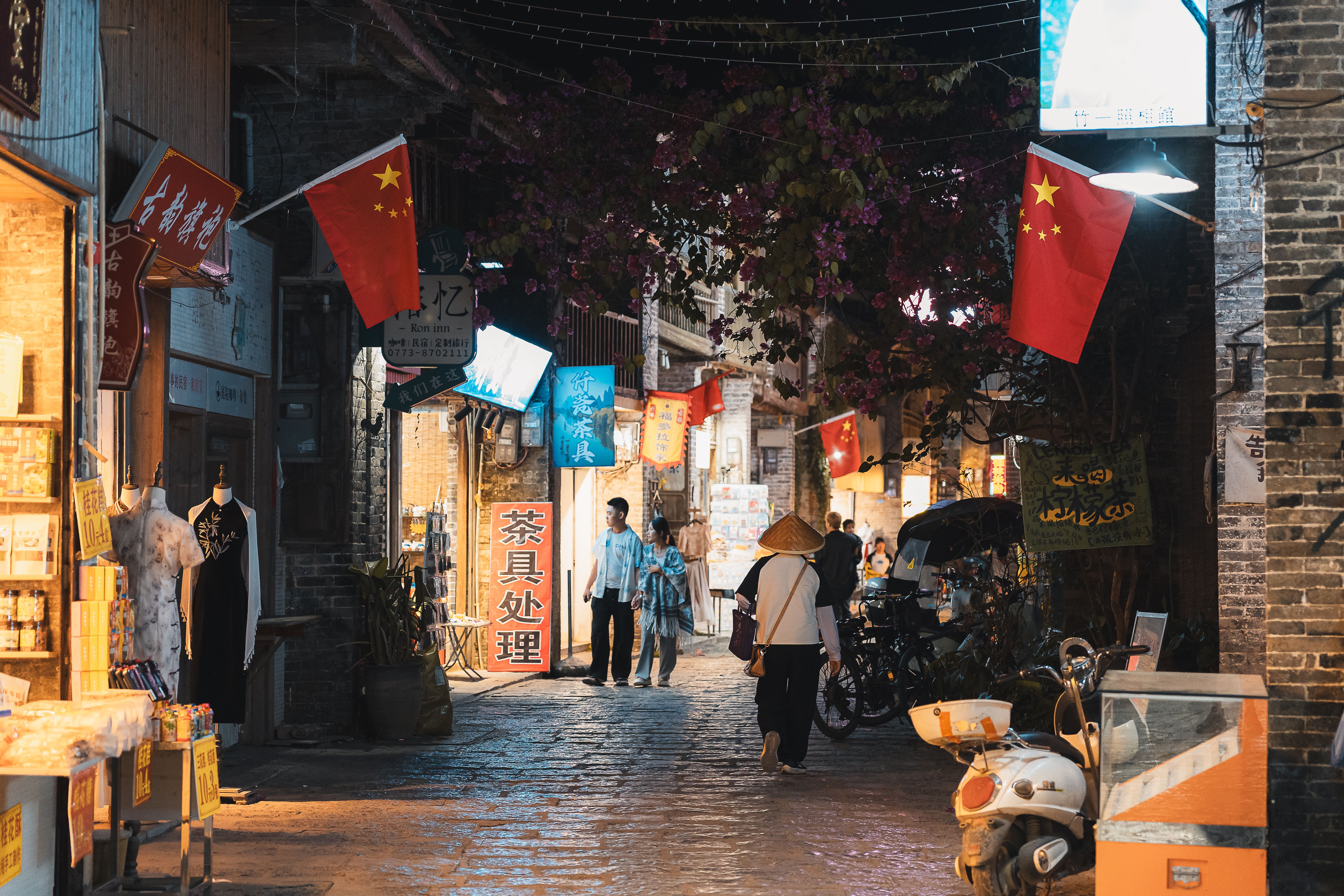 Bustling evening street in Guilin, China, showcasing local shops and Chinese cultural elements.