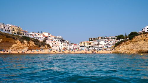 Free Beautiful Algarve beach in Carvoeiro with stunning cliffs and blue waters, perfect for a summer holiday. Stock Photo