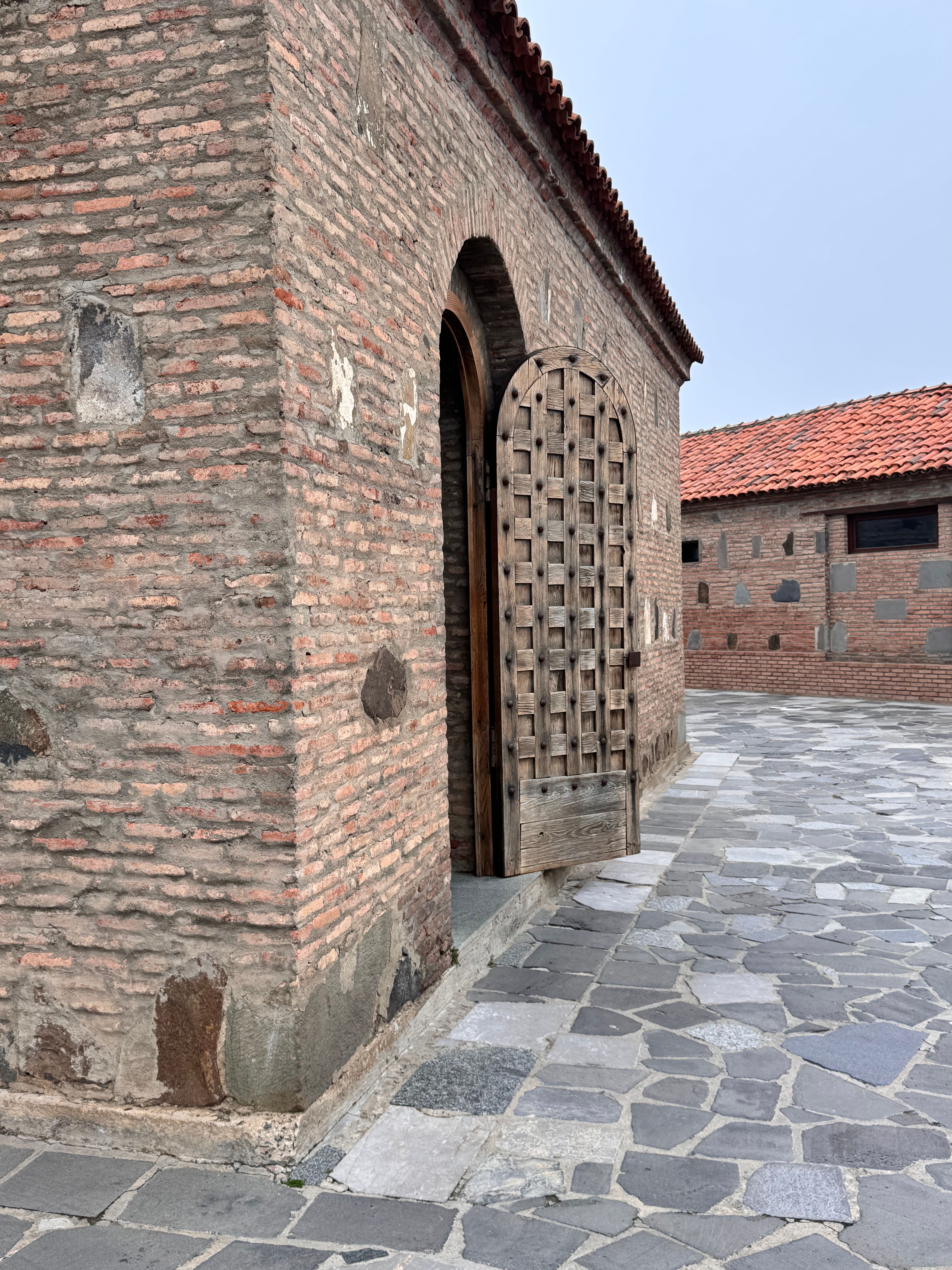 An old stone building with a traditional wooden door in a historic location.