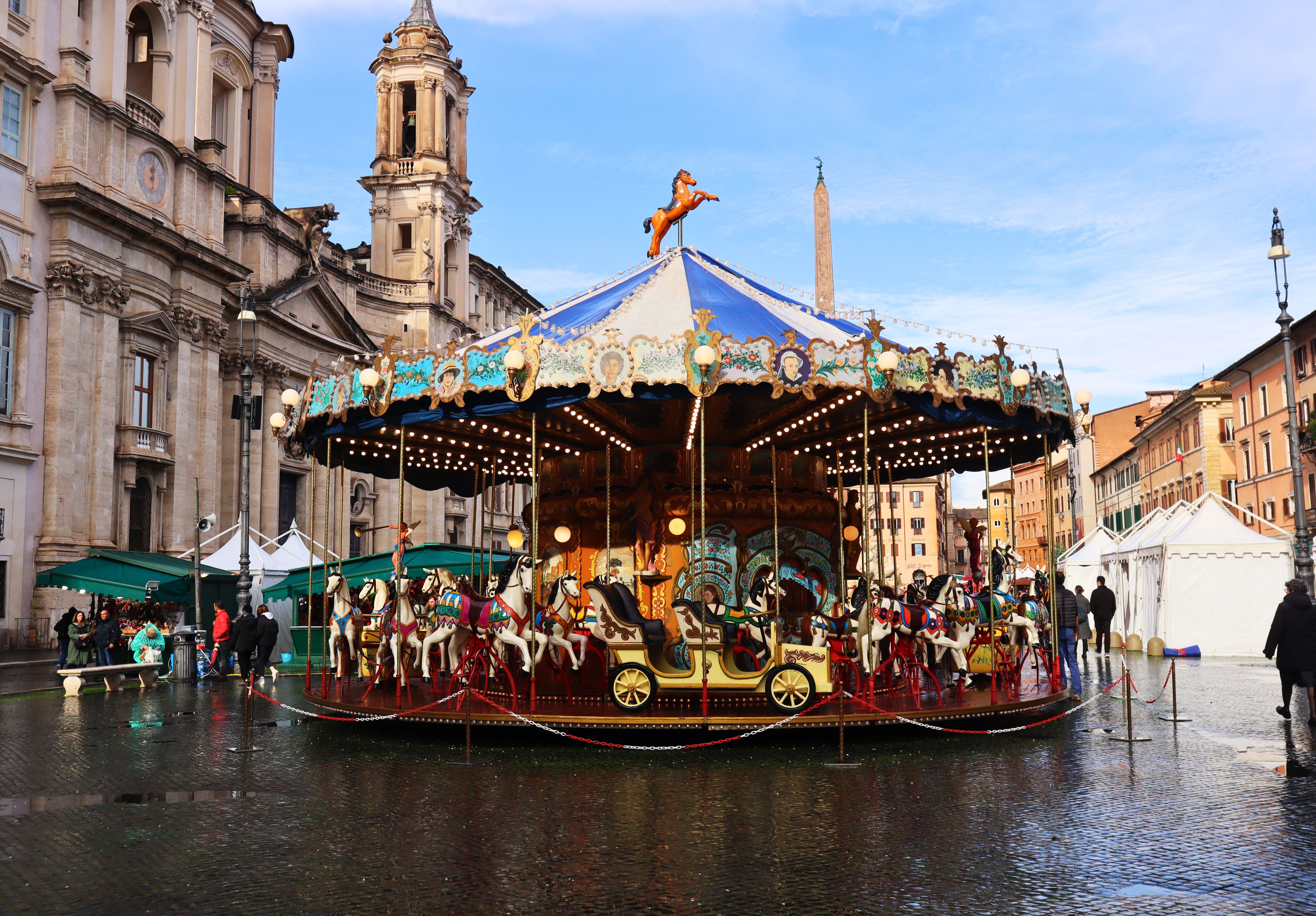 Vibrant carousel spinning at historic Piazza Navona in Rome, Italy. Vibrant carousel spinning at historic Piazza Navona in Rome, Italy.