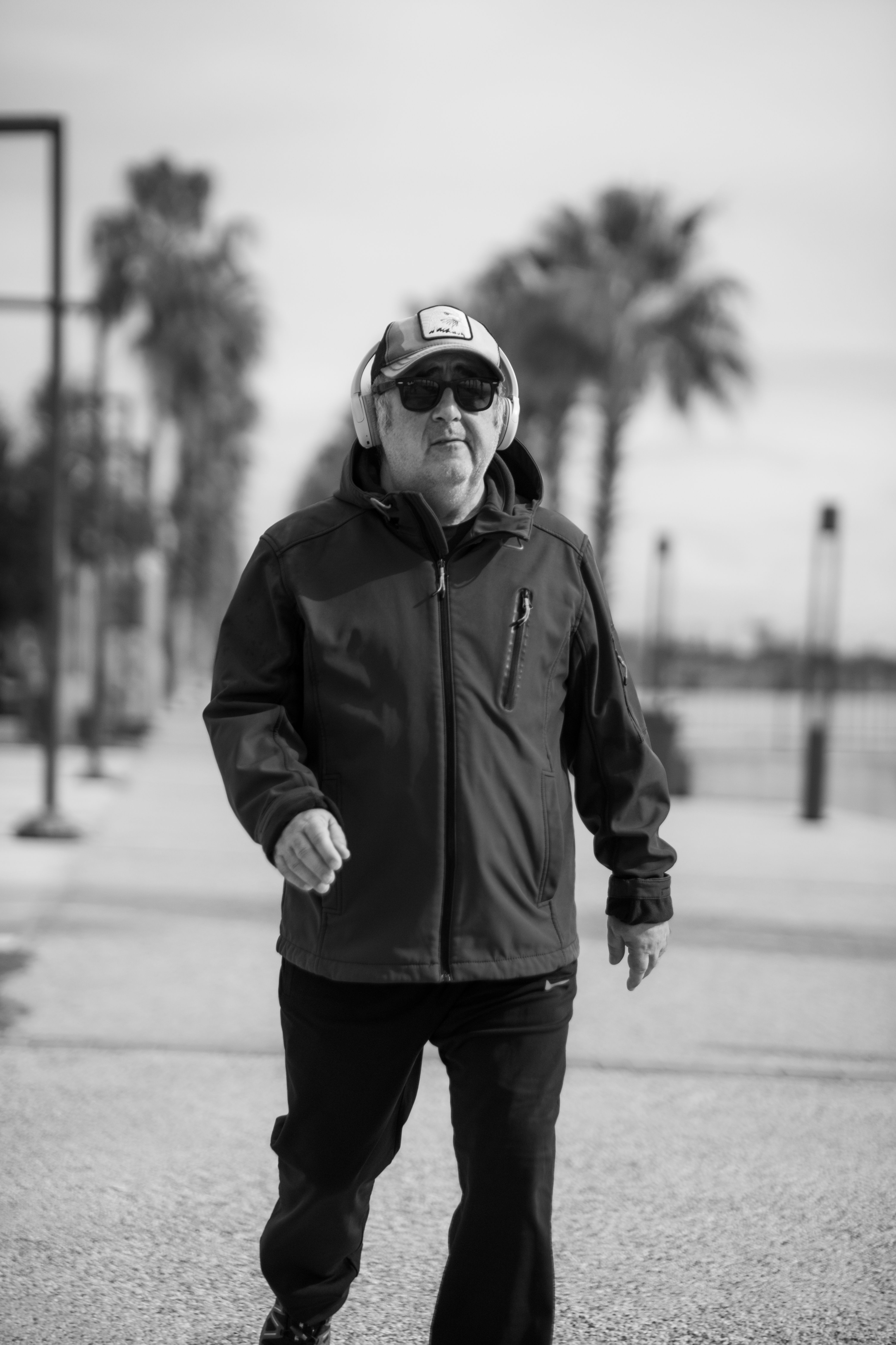 Elderly Man Walking Outdoors in Black and White · Free Stock Photo