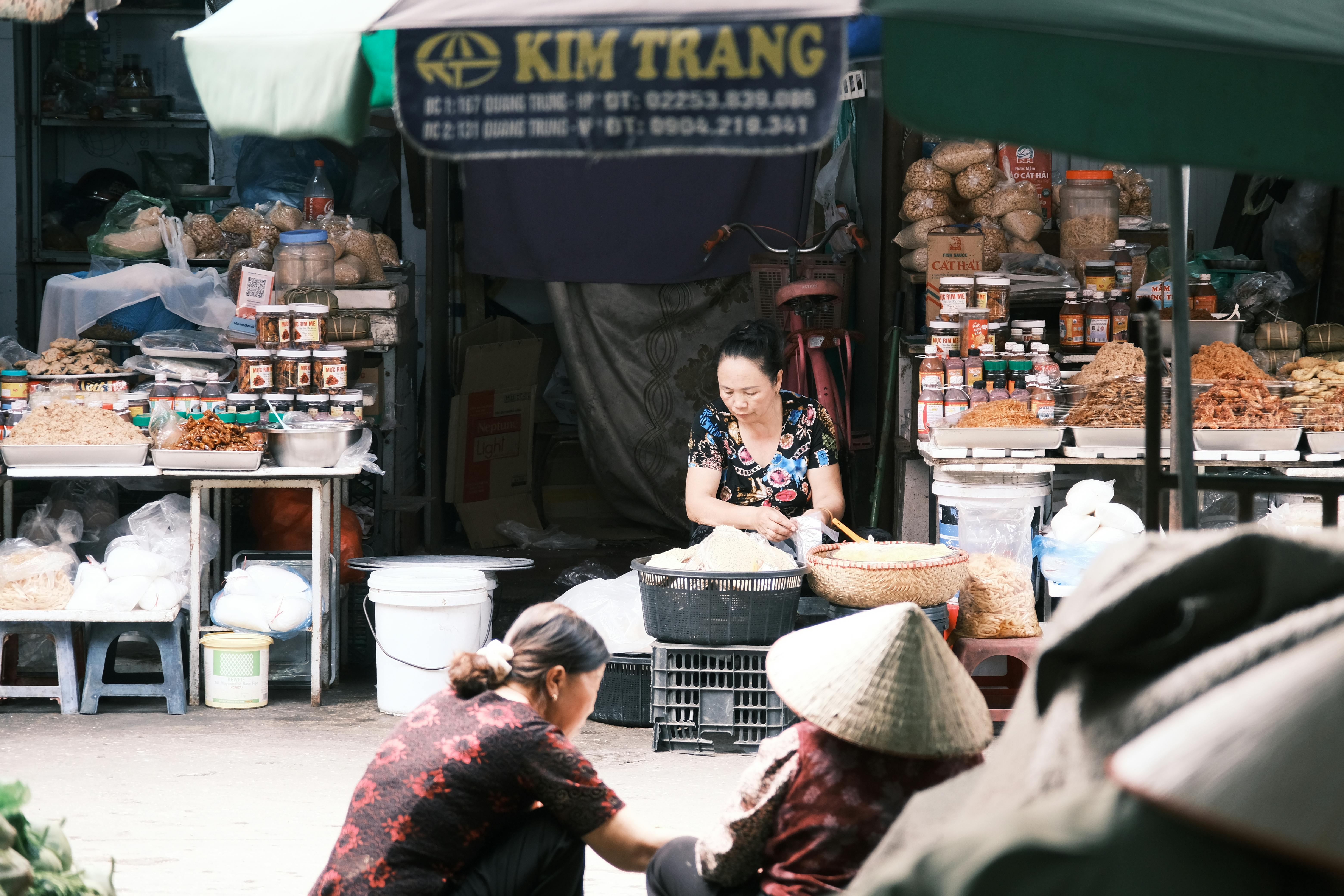 A vibrant market scene in Southeast Asia featuring vendors and local produce.