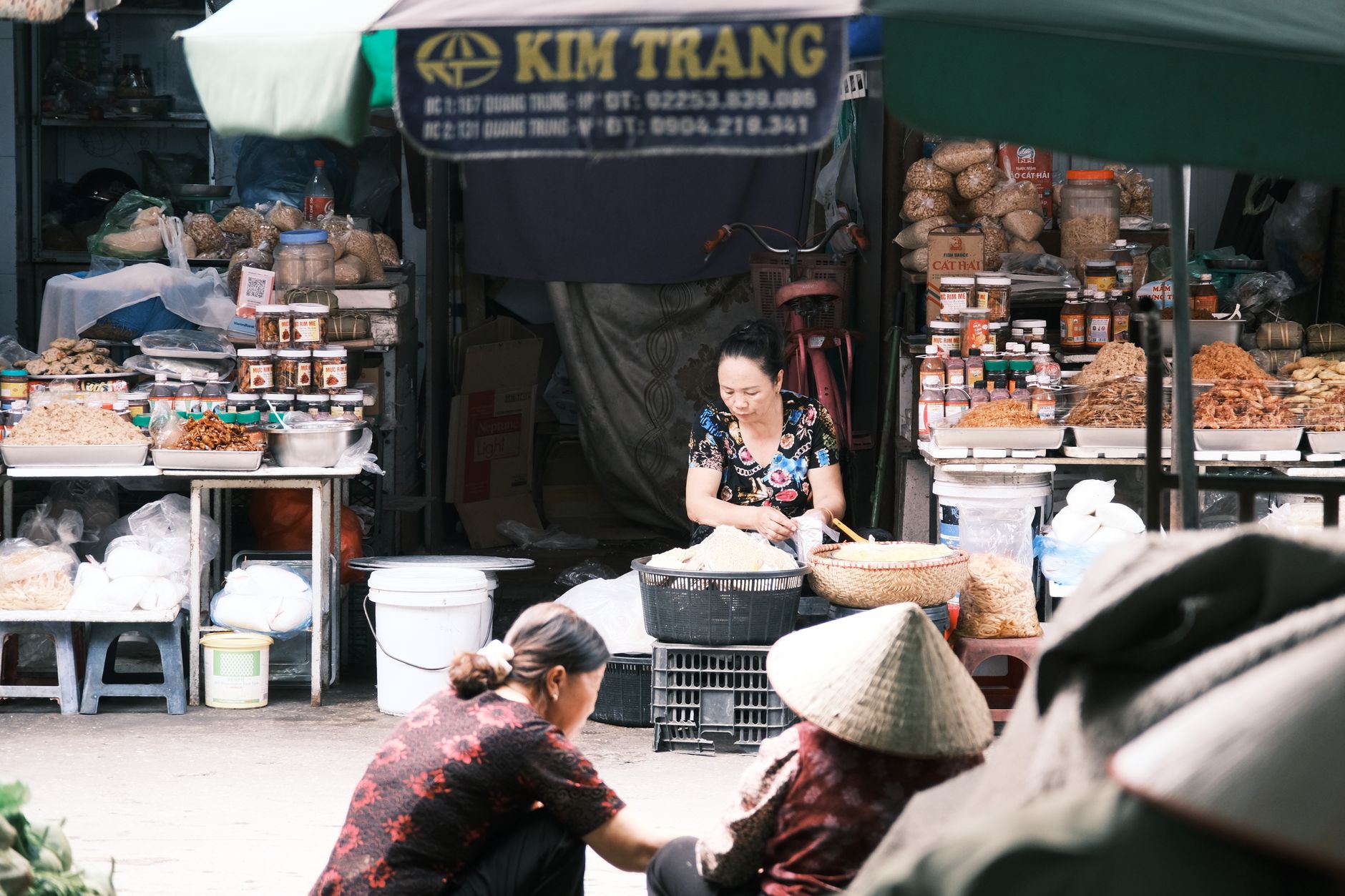 A vibrant market scene in Southeast Asia featuring vendors and local produce.