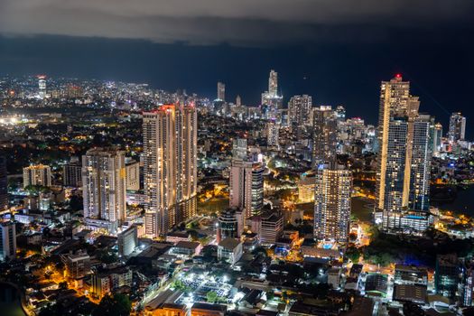 A breathtaking nightscape of Colombo's illuminated skyscrapers and bustling city under a starlit sky.