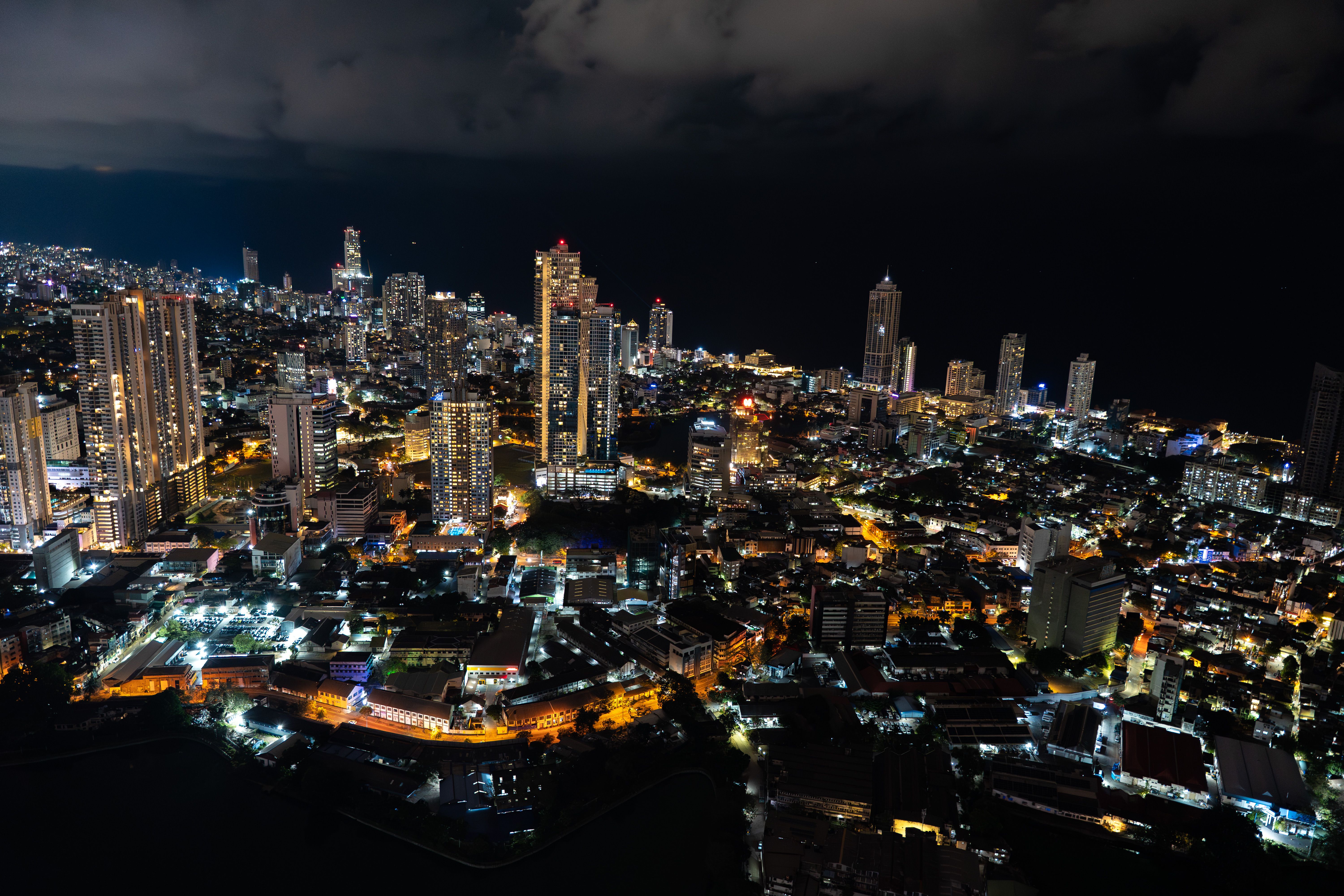 Captivating aerial view of Colombo's illuminated skyline at night, showcasing urban beauty and city lights.