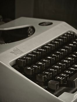 Close-up of an old-fashioned typewriter with typebars in black and white. Perfect for retro themes.