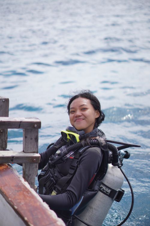 Free A happy young woman prepares for a scuba dive in the waters of Southwest Papua, Indonesia. Stock Photo