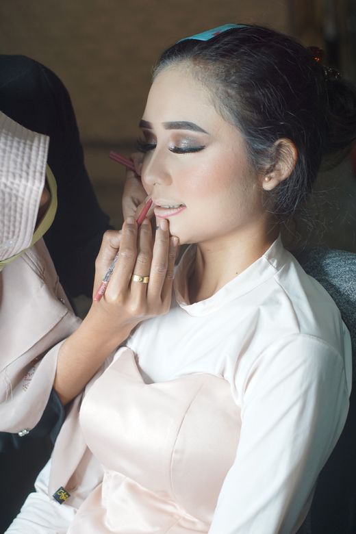 Makeup artist finishing an event look