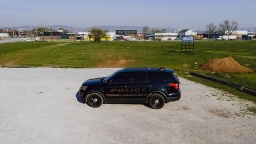 Free A Chattanooga police car is parked in a spacious outdoor area under clear skies. Stock Photo