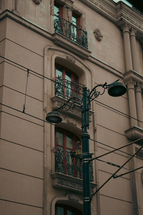Free Close-up view of a classic apartment facade with ornate balconies under overcast skies. Stock Photo