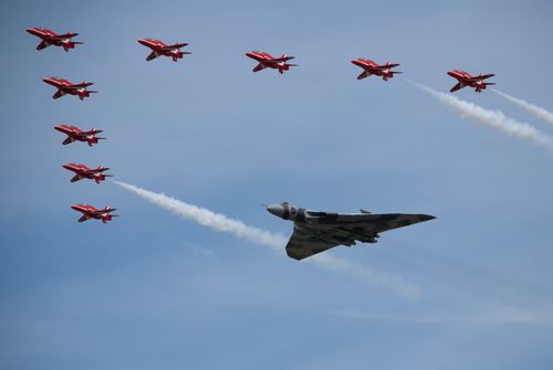Free Impressive aerial display featuring the Red Arrows and a Vulcan bomber at the Fairford airshow. Stock Photo