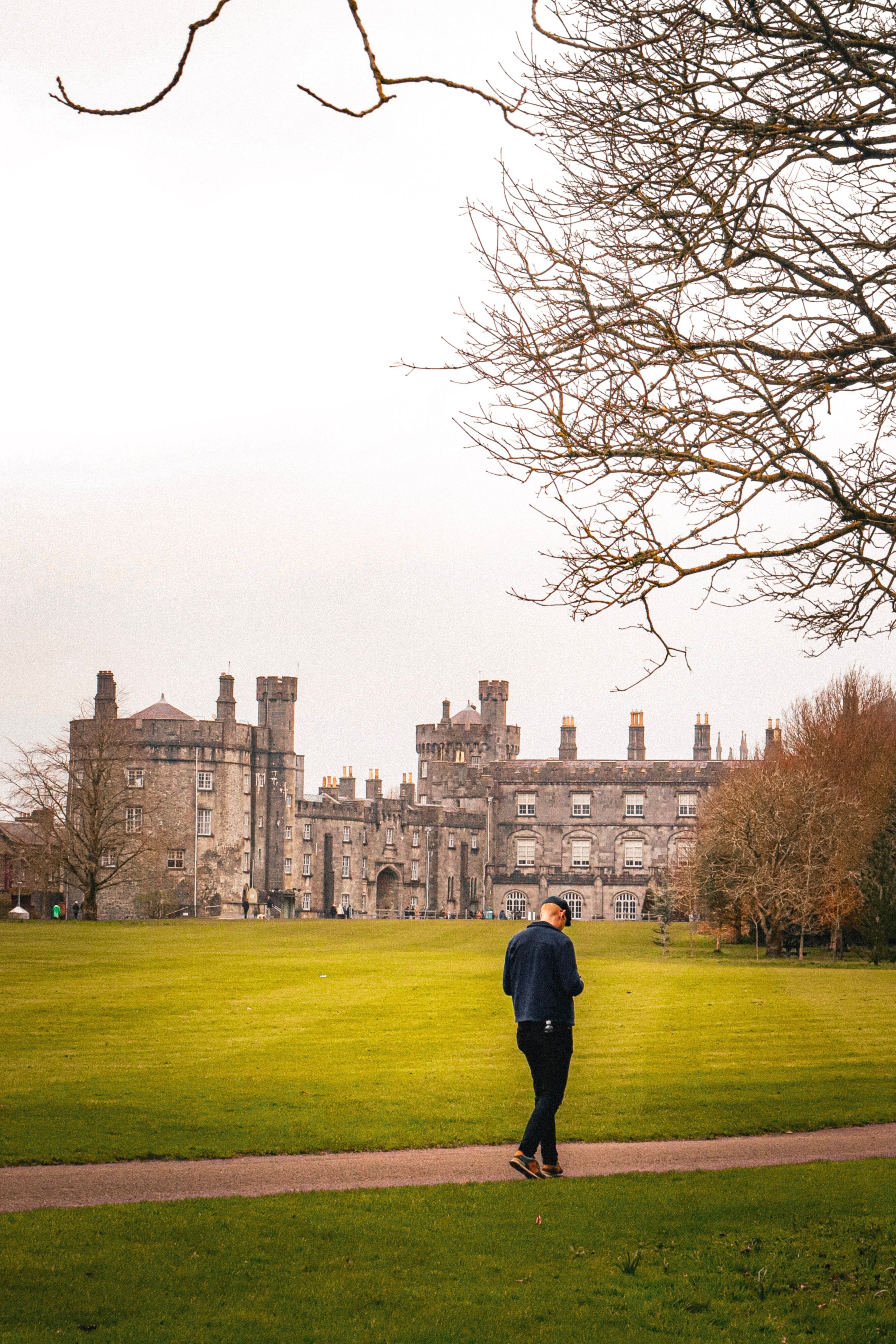 Castle grounds in Kilkenny with a walker