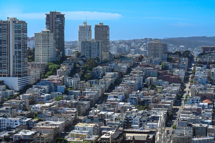 San Francisco skyline with downtown buildings and residential neighborhoods under blue sky